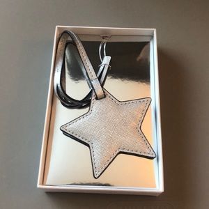 A Michael kors silver star monogram charm